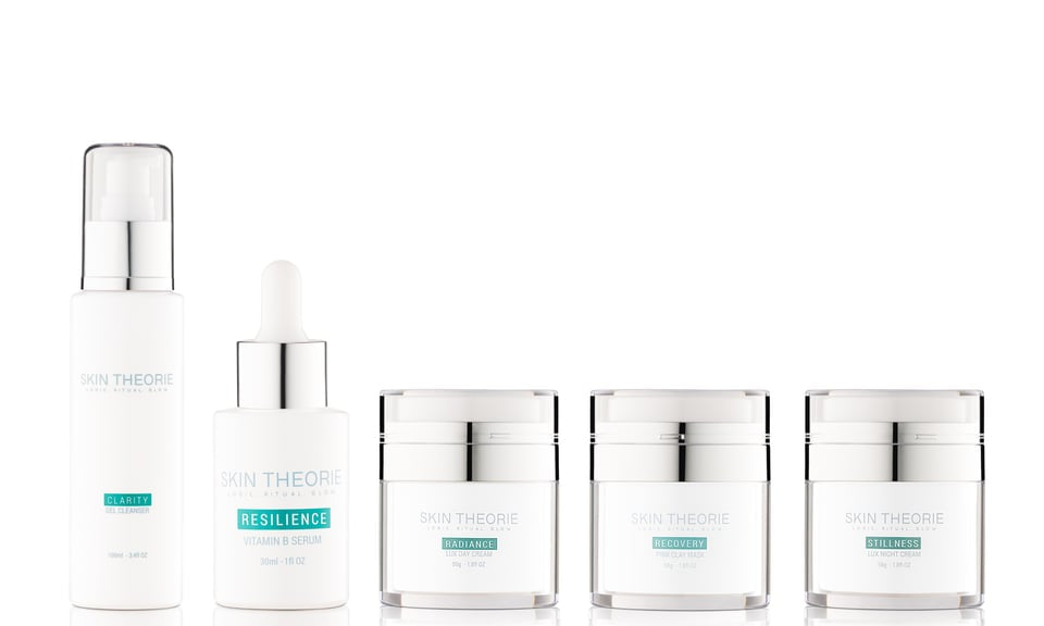 The Skin Theorie Luminary Collection — Clarity gel cleanser, Resilience Vitamin B serum, and Radiance, Recovery and Stillness creams arranged on white.